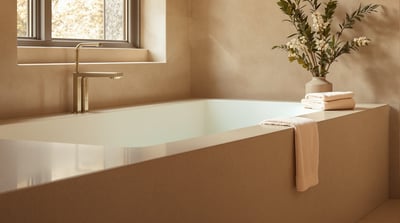 The edge of a bath in a calm bathroom