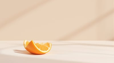An orange half-peeled on plain linen, a close view