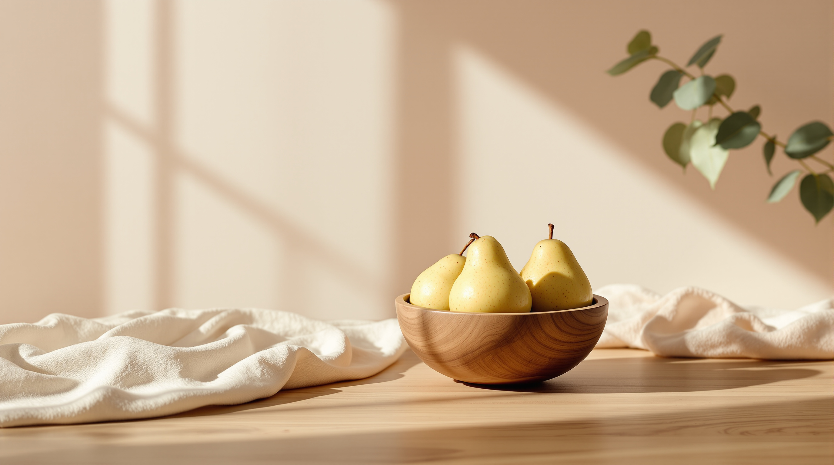 A small plain wooden bowl of pears on bare wood, a close view