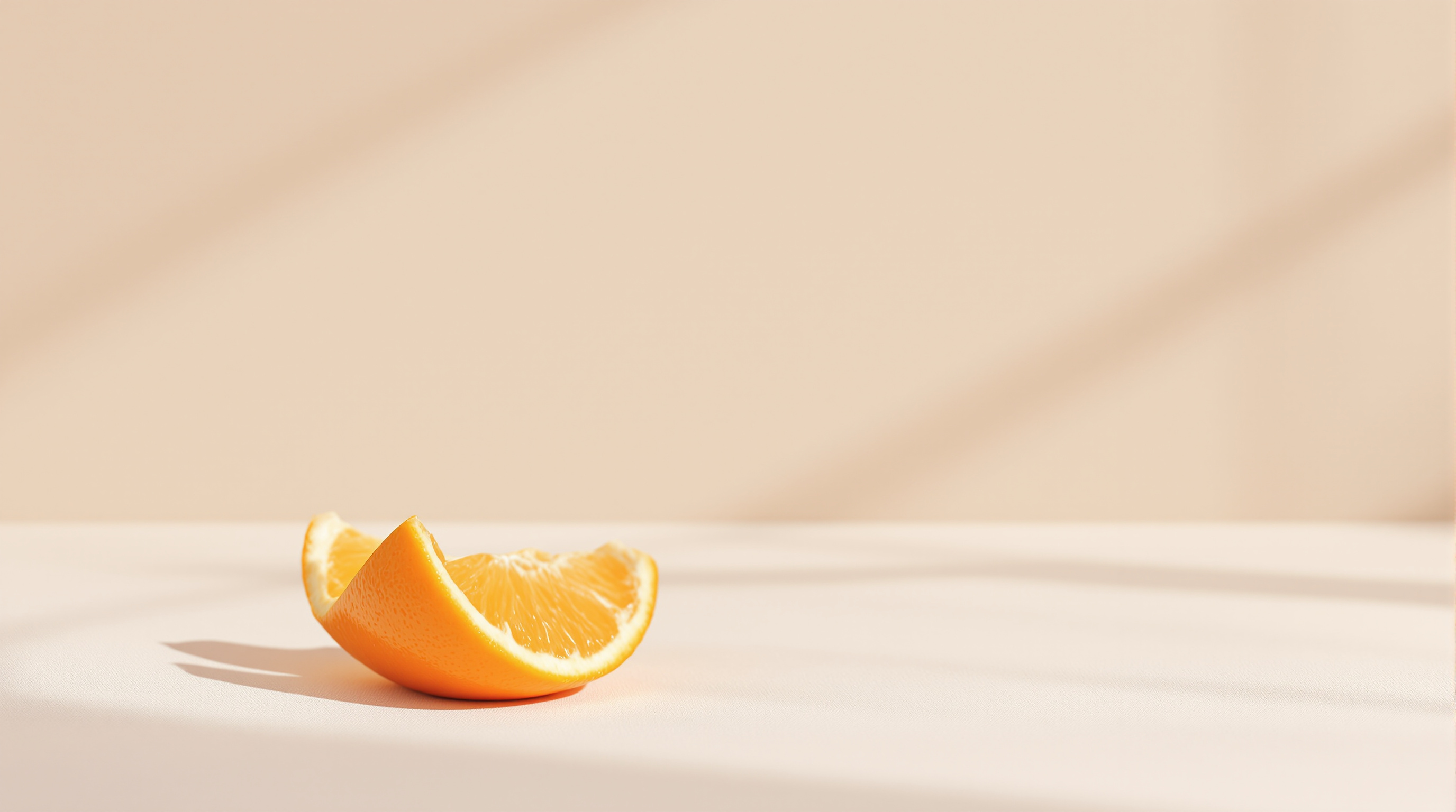 An orange half-peeled on plain linen, a close view